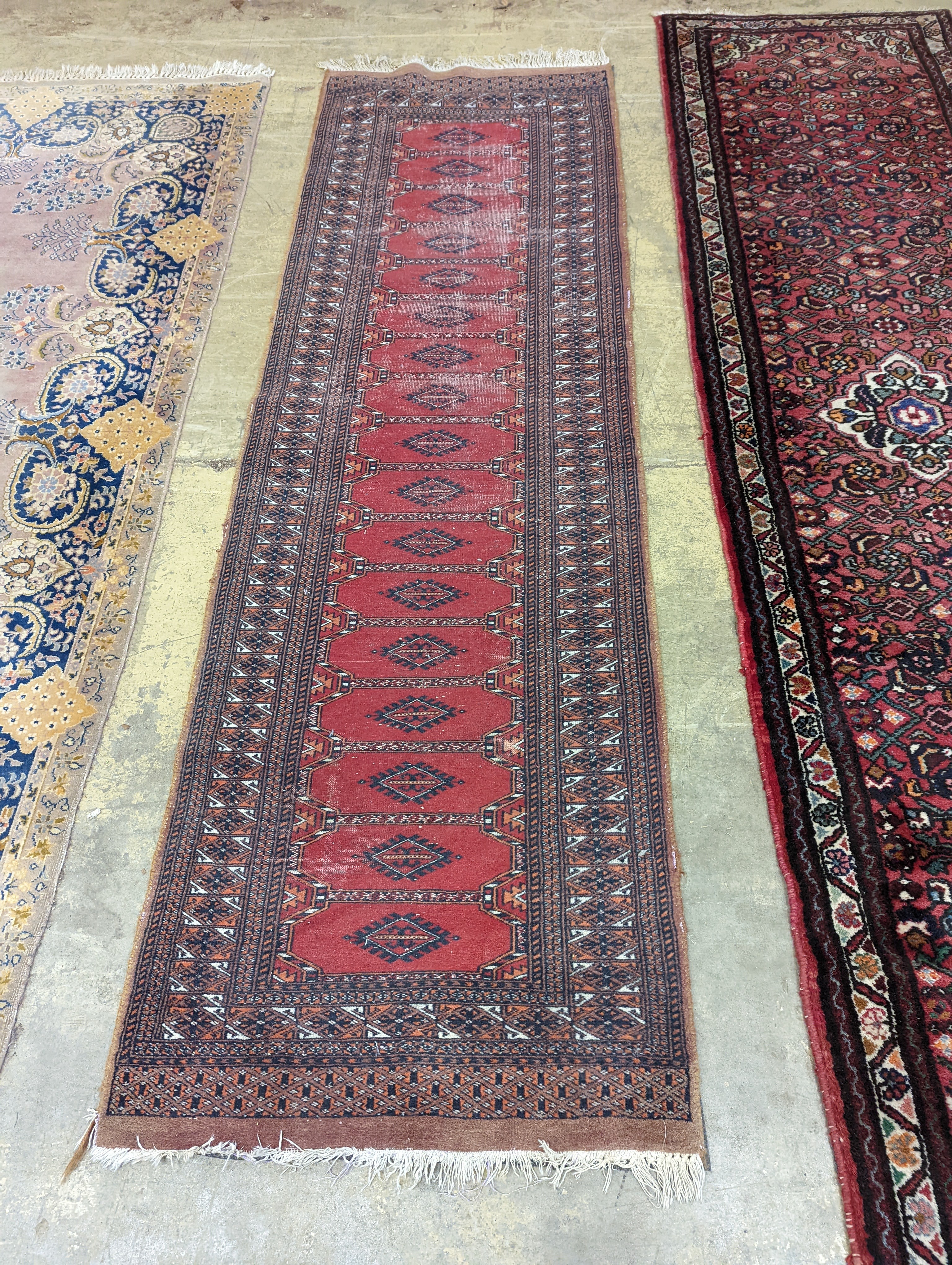 A North West Persian red ground runner and a Bokhara runner, larger approx. 290 x 78cm